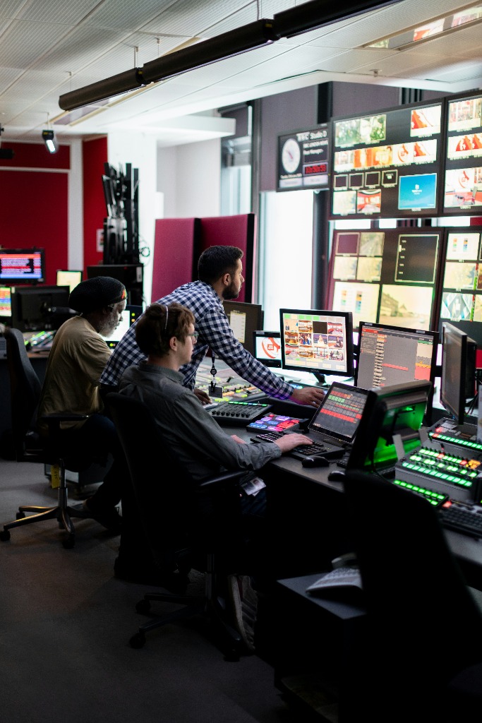 Team monitoring multiple screens and inboxes